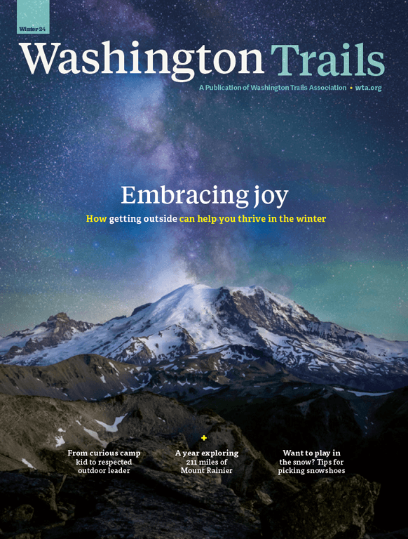 Washington Trails magazine, winter 2024 edition, featuring a photo of Mount Rainier under the milky way. Theme: Embracing joy